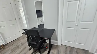 a black desk in a white room with a black chair at Room for rent shared apartment in Hartford