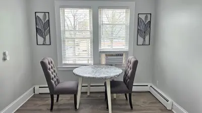 a dining room with a table and two chairs at Room for rent shared apartment in Hartford