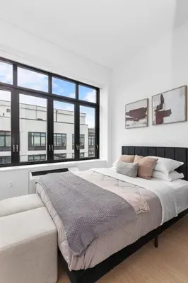 a bedroom with a large bed and a large window at Brooklyn with a View in New York