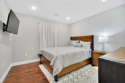 a bedroom with a bed and a flat screen tv at Your home away from home in Newark