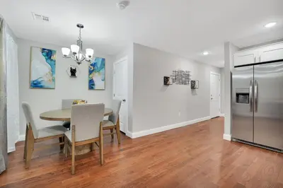 a kitchen and dining room with a table and a refrigerator at Home away from home 2 in Newark