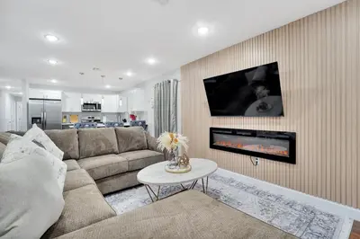 a living room with a couch and a fireplace at Home away from home 2 in Newark