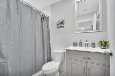 a white bathroom with a toilet and a shower at Home away from home 2 in Newark