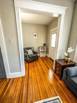 a living room with a couch and a chair at The Red House Albany NY 4 Bedroom Private Apartment in Albany