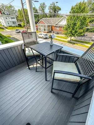 a patio with a table and chairs on a deck at The Red House Albany NY 4 Bedroom Private Apartment in Albany