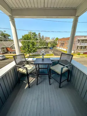 a patio with two chairs and a table on a porch at The Red House Albany NY 4 Bedroom Private Apartment in Albany
