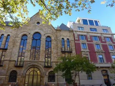 a large brick building with a tree in front of it at Top Rated 1BR - Lenox 127 in New York