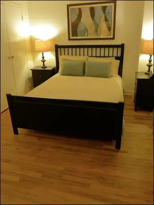 a large bed in a room with two lamps at Top Rated 1BR - Lenox 127 in New York