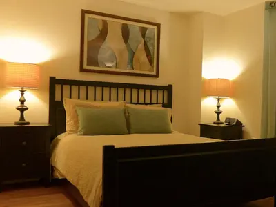 a bedroom with a large bed with two lamps at Top Rated 1BR - Lenox 127 in New York