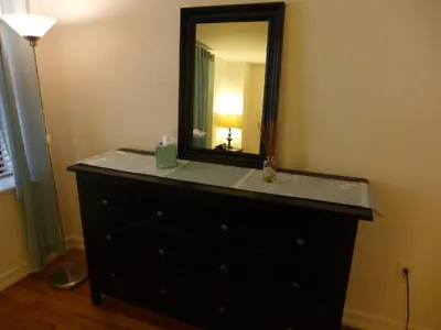 a dresser with a mirror on top of it at Top Rated 1BR - Lenox 127 in New York