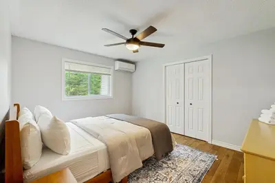 a bedroom with a bed and a ceiling fan at Ski Dreams in Dover
