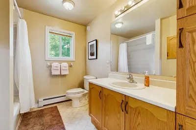 a bathroom with a sink and a toilet and a window at Ski Dreams in Dover