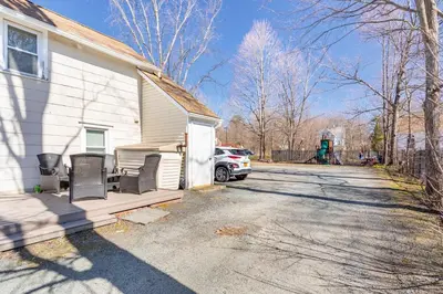 a house with a car parked in the driveway at Heart of Historic Wurtsboro Suite 6 in Wurtsboro