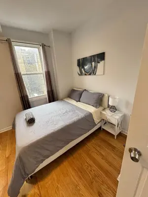 a bedroom with a large bed and a window at 4 ROOMS FAMILY HOUSE WITH BACKYARD, LAUNDRY AND PARKINg in Union City