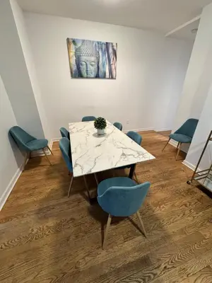 a meeting room with a table and blue chairs at 4 ROOMS FAMILY HOUSE WITH BACKYARD, LAUNDRY AND PARKINg in Union City