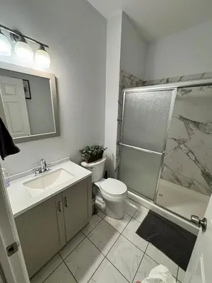 a bathroom with a toilet and a sink and a shower at 4 ROOMS FAMILY HOUSE WITH BACKYARD, LAUNDRY AND PARKINg in Union City