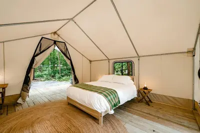a bedroom with a bed in a tent at Classic Safari Tent in the Heart of the Adirondack Wilderness, near Lake George, New York in Corinth