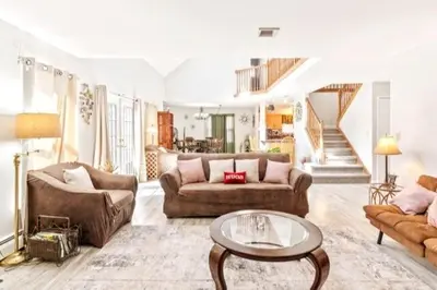 a living room with two couches and a table at Hilltop Villa in East Stroudsburg