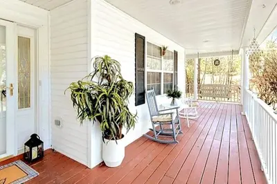 a porch with a chair and a potted plant at Hilltop Villa in East Stroudsburg