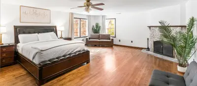 a bedroom with a bed and a fireplace at Lakeside Home in Brookfield