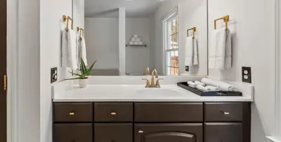 a bathroom with a sink and a mirror at Lakeside Home in Brookfield