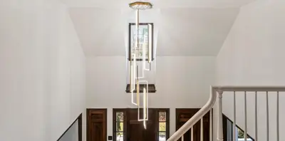 a chandelier hanging from a staircase in a house at Lakeside Home in Brookfield