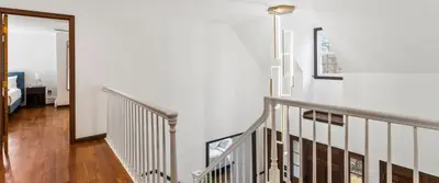 a staircase in a house with white walls at Lakeside Home in Brookfield