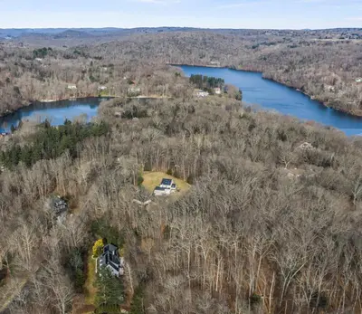an aerial view of a house and a lake at Lakeside Home in Brookfield