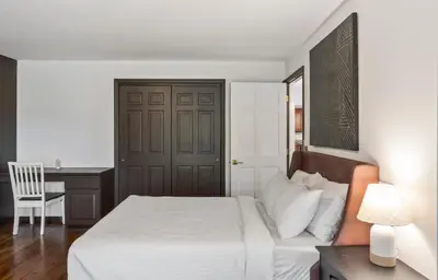 a bedroom with a bed with a desk and a chair at Lakeside Home in Brookfield