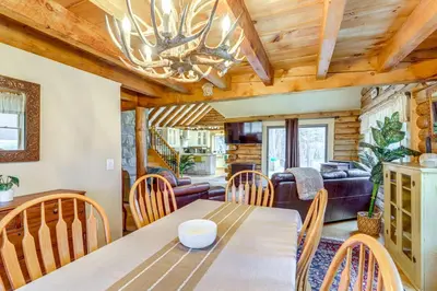 a dining room and living room with a table and chairs at 3 Mi to UMass Amherst Peaceful New England Cabin in Sunderland