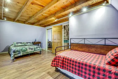 a bedroom with a bed and a couch in a room at 3 Mi to UMass Amherst Peaceful New England Cabin in Sunderland