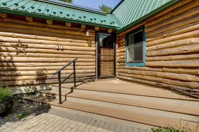 a wooden cabin with a porch and a door at 3 Mi to UMass Amherst Peaceful New England Cabin in Sunderland