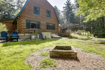 a log cabin with a fire pit in the yard at 3 Mi to UMass Amherst Peaceful New England Cabin in Sunderland