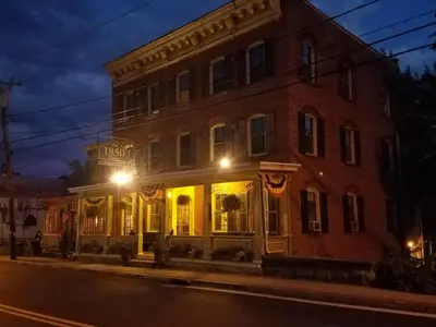a large brick building on a city street at night at Six Bells Countryside Inn in Rosendale