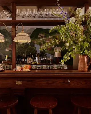a bar with a vase of flowers and wine bottles at Six Bells Countryside Inn in Rosendale