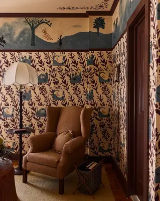 a living room with a chair and wallpaper at Six Bells Countryside Inn in Rosendale