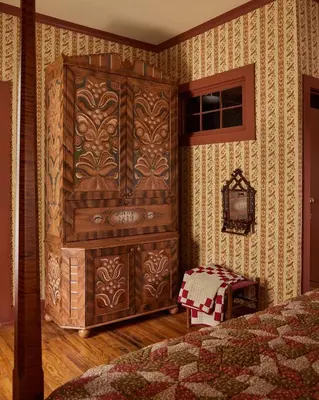a bedroom with a large wooden cabinet in the corner at Six Bells Countryside Inn in Rosendale