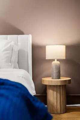 a lamp on a table next to a bed at Beautifully designed 3 BDR in Dumbo NYC in Brooklyn