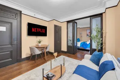 a living room with a couch and a table at NYC Premier Walking Distance to Times Square in New York