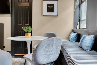 a room with a table and two chairs and a table at NYC Apartment in The Best Location! Walking Distance to Everything! in New York
