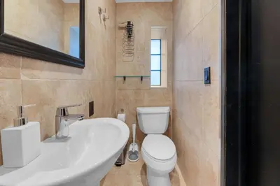 a bathroom with a white toilet and a sink at NYC Apartment in The Best Location! Walking Distance to Everything! in New York