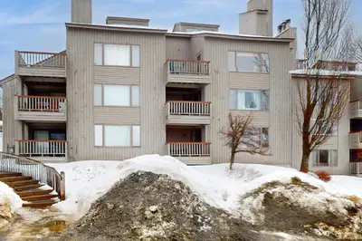 an apartment building with snow in front of it at Snow Tree 337H in Dover