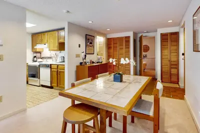 a kitchen and dining room with a wooden table and chairs at Snow Tree 337H in Dover
