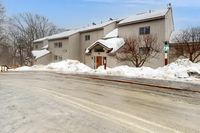 a building with snow on the side of a road at Snow Tree 337H in Dover