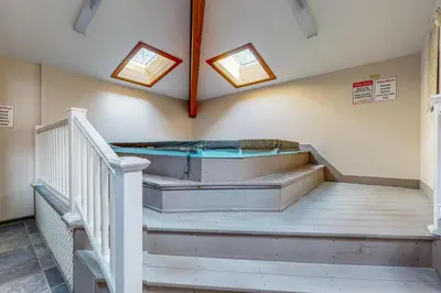 a jacuzzi tub in a room with stairs at Snow Tree 337H in Dover