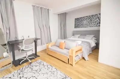 a bedroom with a bed and a desk and a chair at The Gray Loft Escape NYC Edition. in New York