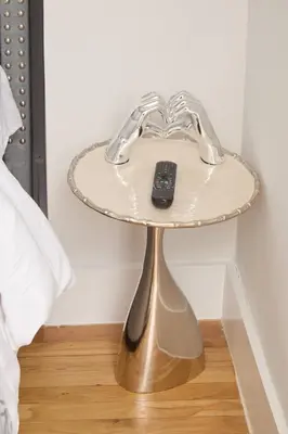 a glass table with a remote control on top of it at The Gray Loft Escape NYC Edition. in New York