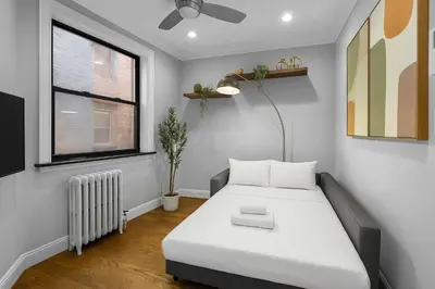 a small bedroom with a bed and a window at Modern Manhattan Stay in Prime Spot in New York