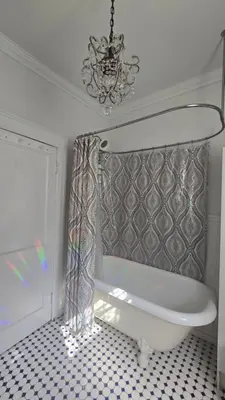 a bathroom with a chandelier and a white tub at 1920s Phoenicia Bungalow with Vintage Furnishings, Sauna, Fireplace, & Fenced Backyard in Phoenicia