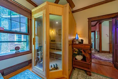 a home with a walk in closet and a glass door at 1920s Phoenicia Bungalow with Vintage Furnishings, Sauna, Fireplace, & Fenced Backyard in Phoenicia